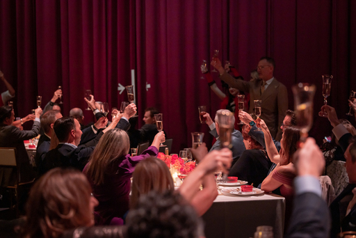 Dinner on Stage attendees toast the evening.jpg